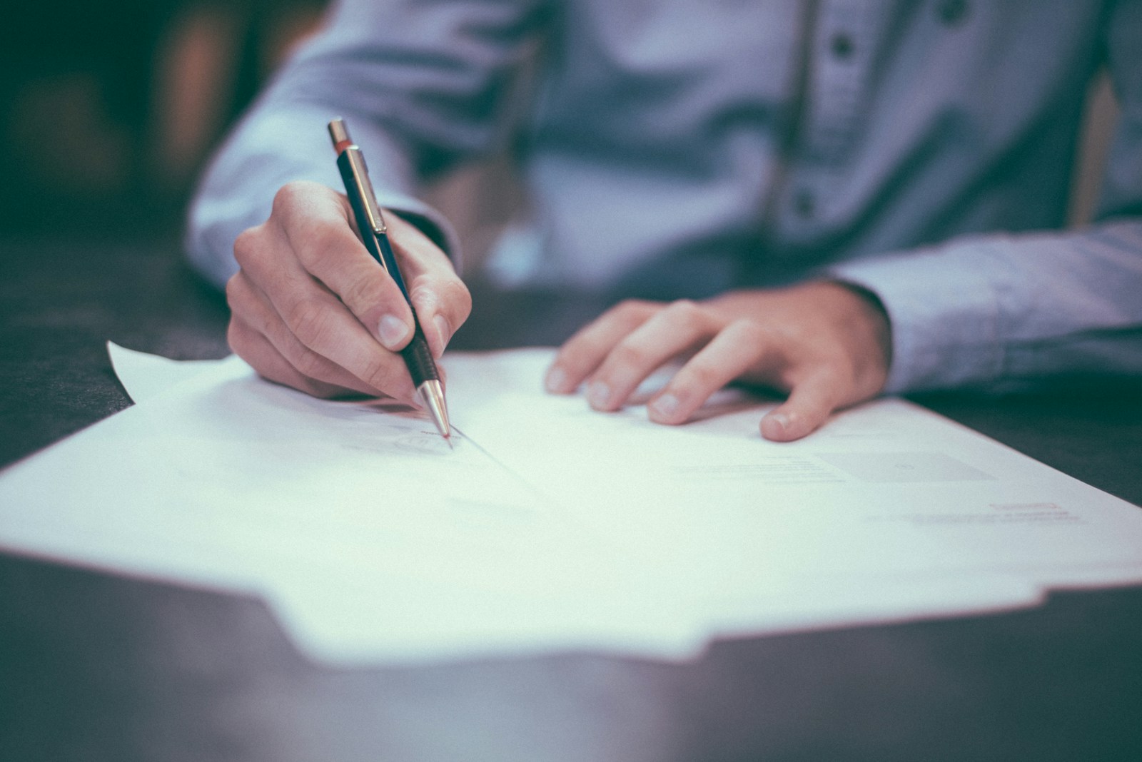 Senior counsel reviewing joint venture agreements and structured docket files at LegalTrace